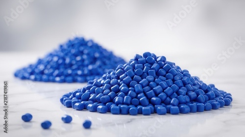 Obraz na płótnie Blue plastic pellets piled on a white marble surface.