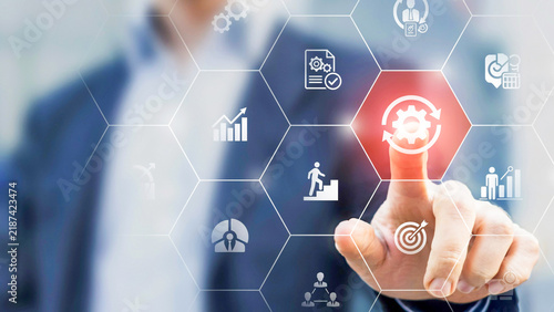 Business professional's hand interacts with a glowing digital interface, highlighting strategic process optimization, workflow automation, and management solutions for efficiency and growth