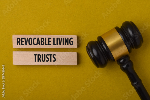 Legal estate planning concept featuring a gavel and blocks labeled Revocable Living Trusts, representing inheritance, asset protection, wealth management, and family planning.