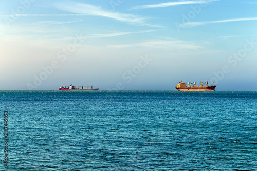 Rendezvous of two ships on the high seas. Strait of Hormuz. Tanker ship on the horizon
