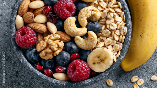 A vibrant bowl filled with fresh fruits, nuts, and oats, highlighting a healthy breakfast option rich in nutrients and flavors, perfect for fueling an active lifestyle.
