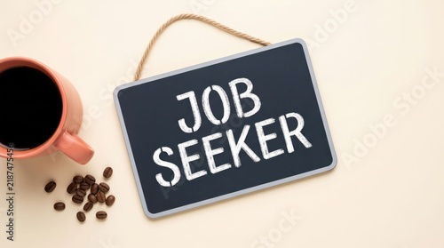 Chalkboard tag displaying job seeker text next to a coffee cup