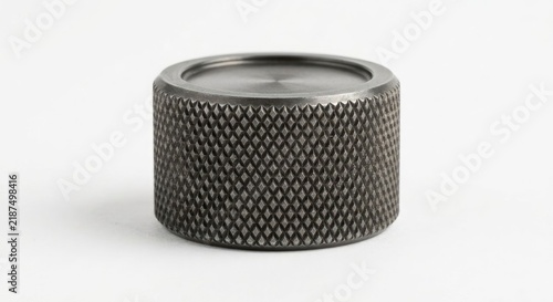 Industrial knurled metal dial on a white background.
