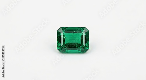 Tapety artystyczne Rectangular emerald cut green gemstone on white background.
