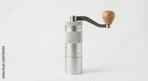 Silver manual coffee grinder with wooden handle crank.