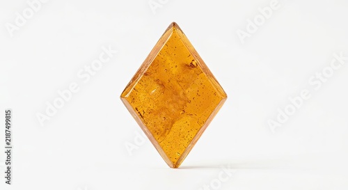 Translucent diamond shaped amber resin geometric object.
