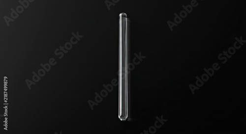 Vertical glass rod on dark background.