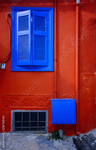 Blue shutters on a red house in Anafiotika, Athens