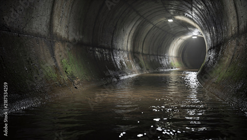 underground concrete drainage tunnel with flowing water and mounted ceiling lights