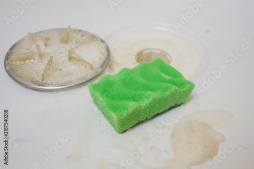 Картината върху платно Metal shower drain with soap foam and green sponge - concept of effective bathroom cleaning, freshness and home hygiene