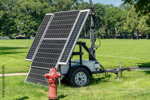 Bild auf Leinwand Portable solar panels mounted on a wheeled cart, designed for easy transportatio