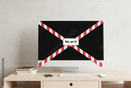 Computer monitor with red and white warning tape and no wifi sign on screen