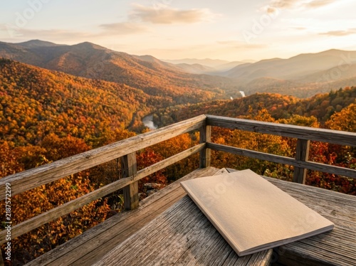 Blank travel magazine mockup on wooden deck with autumn mountain landscape view at sunset