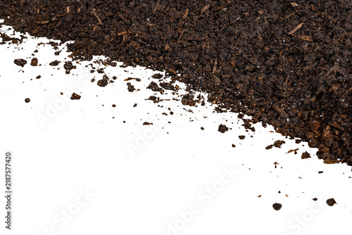 Fotografie Dark brown fertile organic soil diagonal border frame with scattered earth textu
