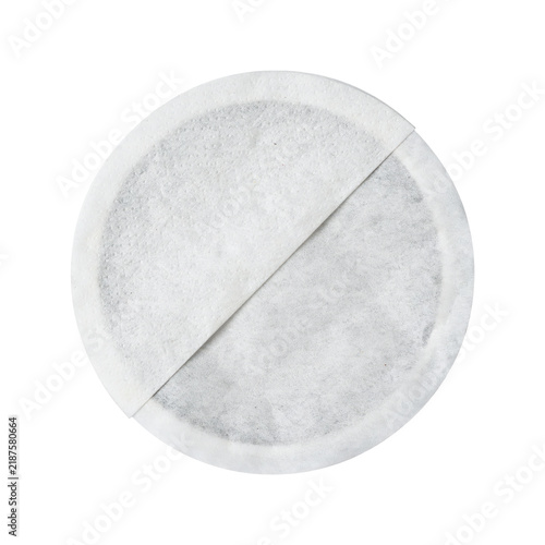 Round white paper coffee pod or tea bag filter with a diagonal seam line across the surface isolated on a transparent background