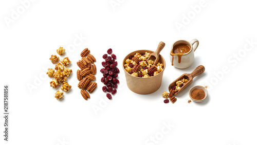 Granola with Cinnamon, Nuts, and Dried Fruits, Brown Wooden Bowl and Scoop, Healthy Breakfast Food Arrangement on White Background Thanksgiving