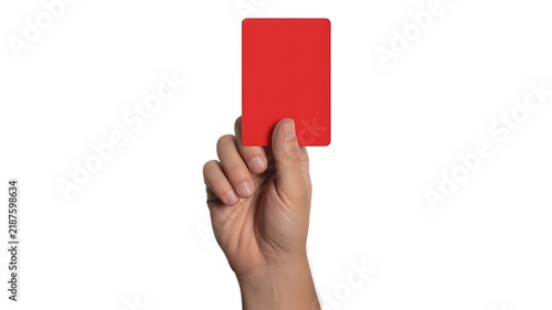 A close-up photograph of a hand holding up a vibrant red penalty card to signal an official warning during a sports match