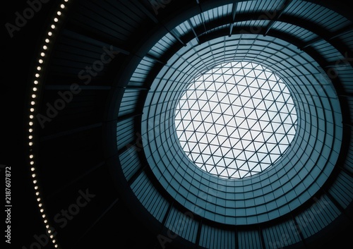 Low angle view of a circular architectural skylight with geometric metal grid patterns