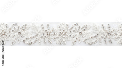 Elegant white lace trim with sparkling rhinestones isolated on transparent background