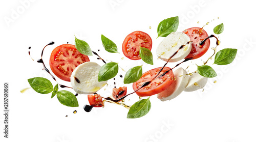 Caprese salad ingredients flying, sliced tomatoes, mozzarella cheese, basil leaves, olive oil and balsamic glaze, isolated on transparent background