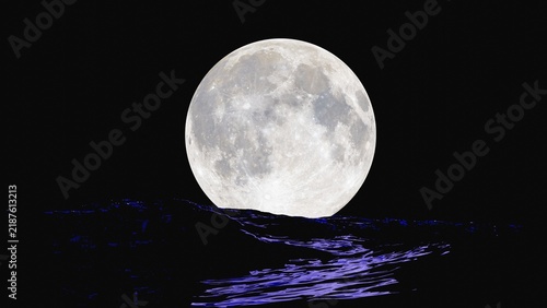 Full moon in the night sky over stormy ocean waves