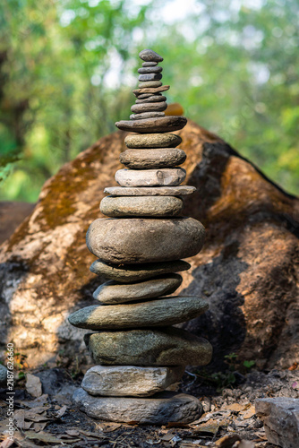 Sticker Balanced rock cairn stacked in natural forest environment for mindfulness concep
