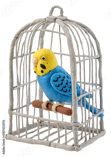 Handmade blue budgie bird sculpture in a white clay cage on a perch