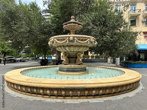 Картината върху платно Antique fountain in the city park in summer.