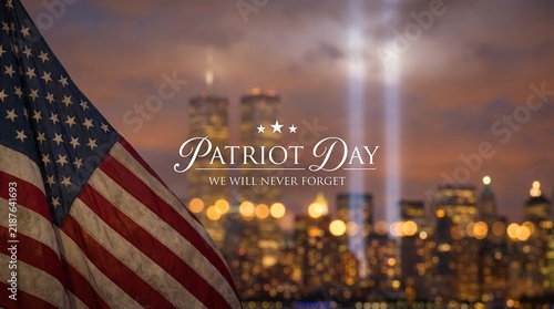 American flag featuring Patriot Day tribute text and light beams over New York skyline for September 11 memorial.