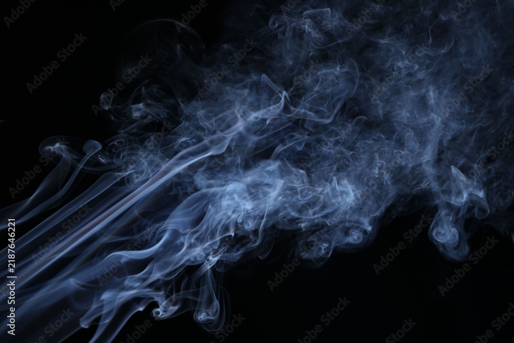 Obraz premium Beautiful smoke in light on black background
