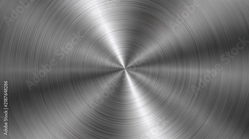 Circular brushed metal texture with radial light reflections on a steel surface