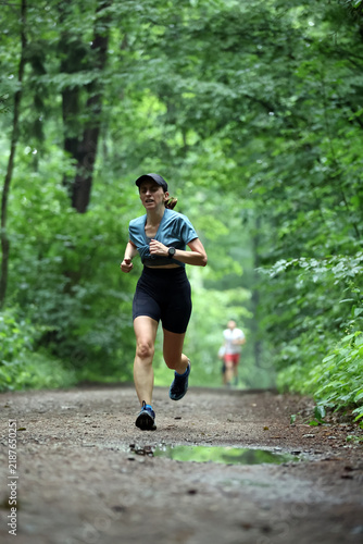 Athletic Woman Running on Forest Trail