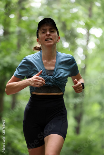 Athletic Woman Running on Forest Trail