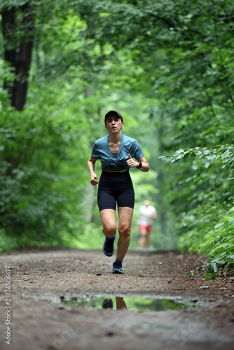 Athletic Woman Running on Forest Trail