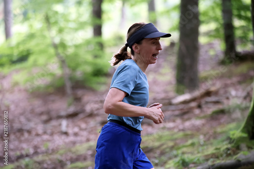 Athletic Woman Running on Forest Trail