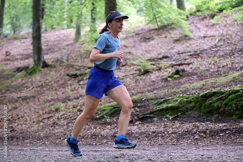 Athletic Woman Running on Forest Trail