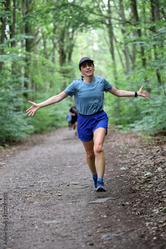 Athletic Woman Running on Forest Trail