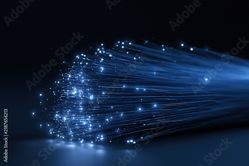 Close-up of illuminated fiber optic cable strands with blue light