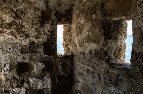 Loopholes in stone corner tower on the outer fortress wall in Larnaka Medieval Fort in Larnaca in the Cyprus