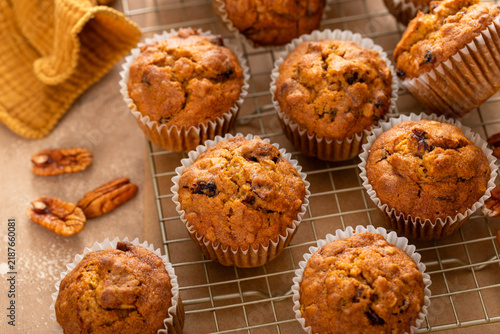 Pumpkin muffins with pecans and dried cranberries on a cooling rack