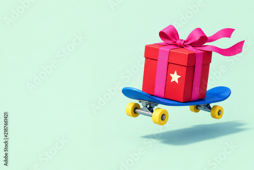 Gift box on skateboard delivering fast present