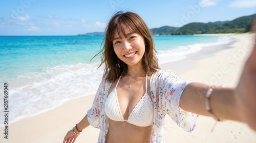 Woman wearing a floral haori and white swimwear smiling by the seaside