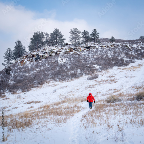 male hiker in winter scenery of Rocky Mountains foothills in northern Colorado, Lory State Park