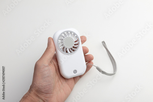 Hand Holding White Portable Mini Fan with Lanyard on White Background