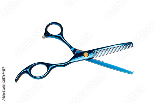 Scissors with a blue handle cut hair in a beauty salon during a hairstyling session