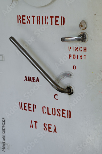 Canvastavla Weather-tight door on board an offshore support vessel, clearly marked “RESTRICT
