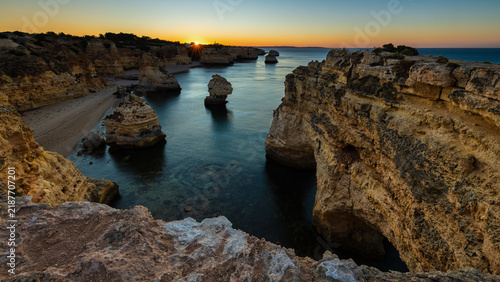 Golden Sunset Between Dramatic Coastal Cliffs at Praia da Marinha, Algarve, Portugal