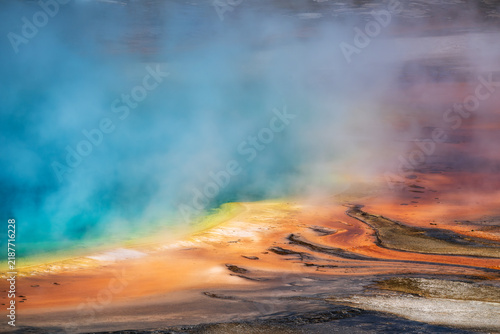 Cuadro en lienzo Vivid turquoise hydrothermal pool and orange mineral terraces with vapor at Yellowstone National Park