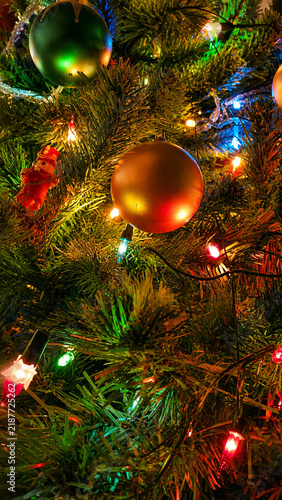 Close-up of Colorful Christmas Tree with Ornaments and Multicolored Lights