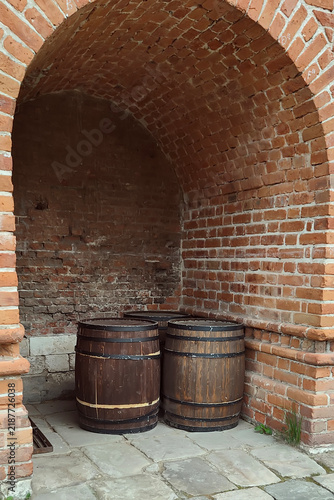 Wooden barrels in an old brick vaulted alcove